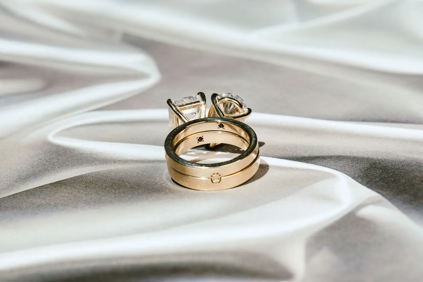 a two piece toi et moi engagement ring, made of 2 rings that fit together like a puzzle piece. Showing the back side of the ring where there's a cat paw puzzle piece detail.