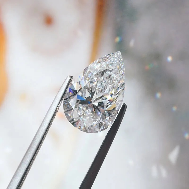 Pear diamond: a loose pear-cut diamond held in tweezers