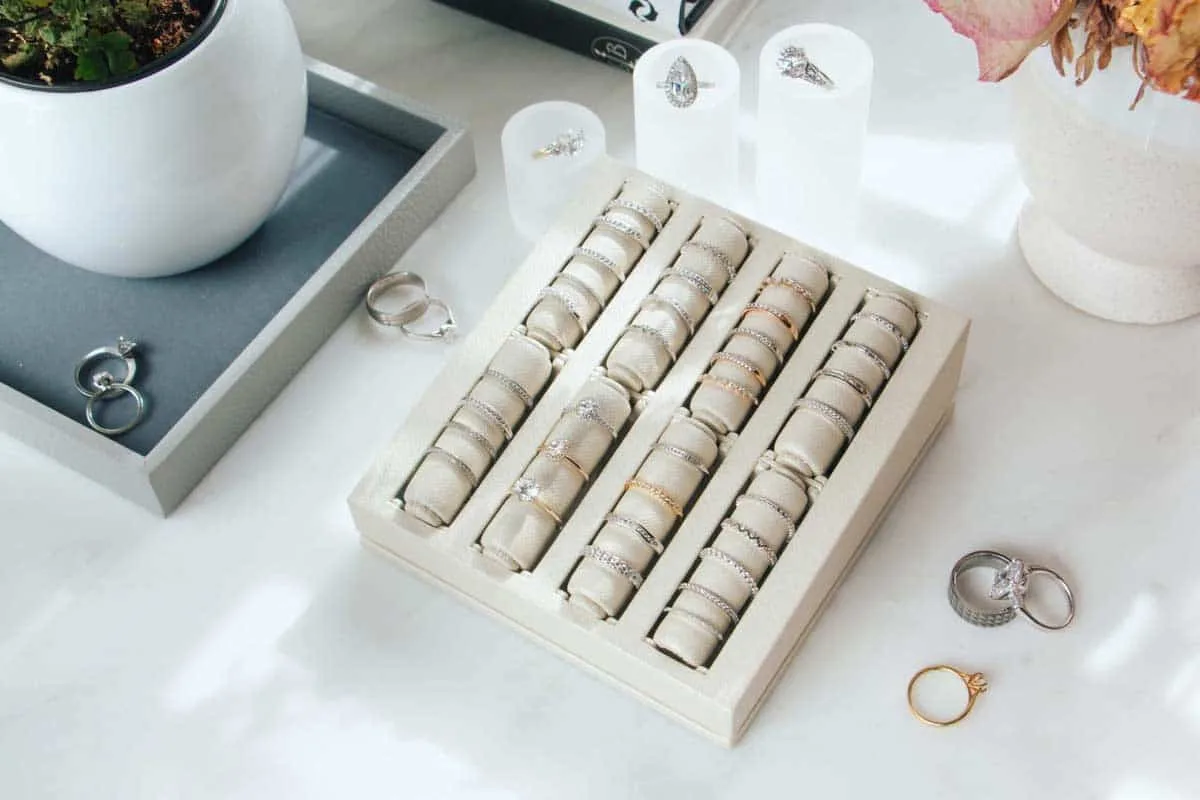 Tray of sample rings on the Engage Studio counter with loose rings and a potted plant