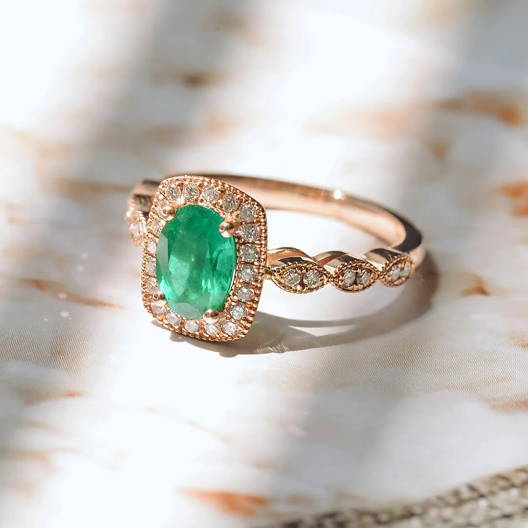 Oval green emerald halo engagement ring in rose gold with a diamond-set band
