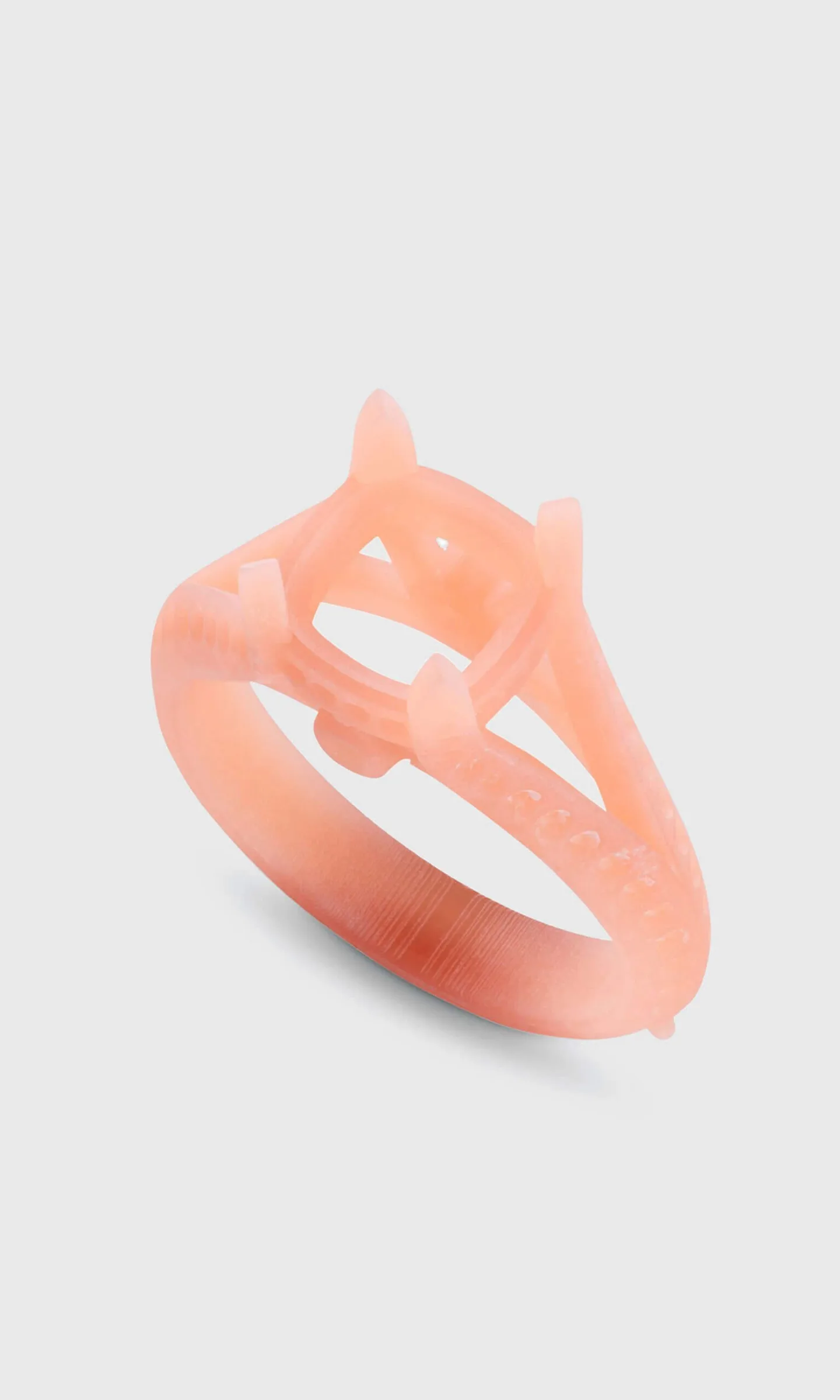 3D-printed resin model of the engagement ring setting in coral-pink resin