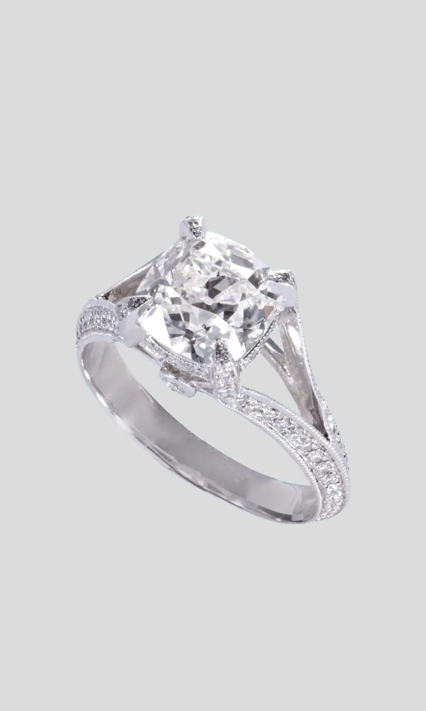 The finished cushion-cut diamond engagement ring in white gold with a pavé split shank