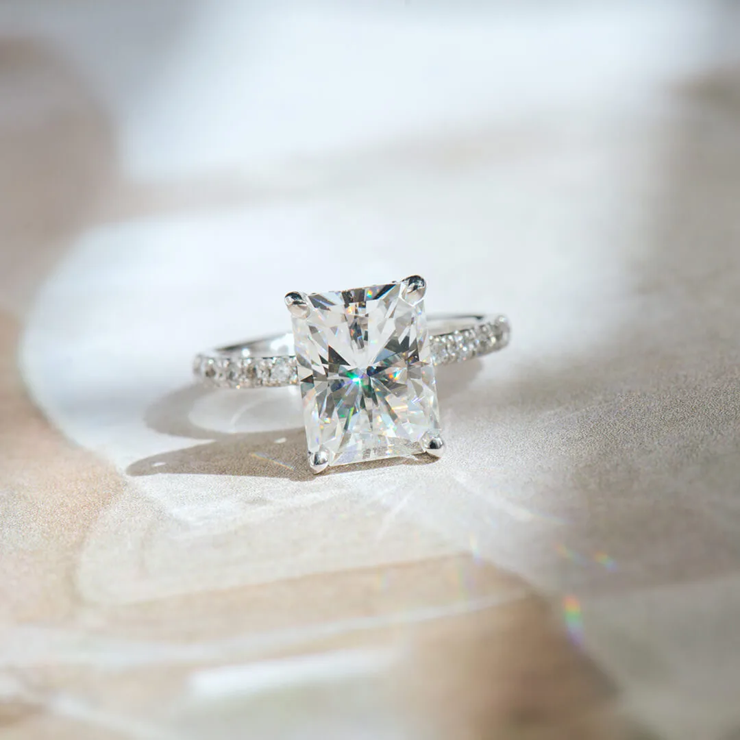 Radiant-cut moissanite engagement ring in white gold with a pave band