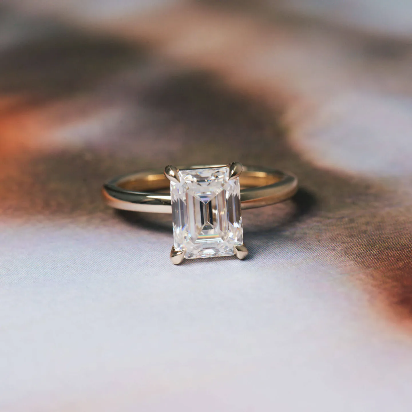 Emerald-cut moissanite solitaire engagement ring in yellow gold