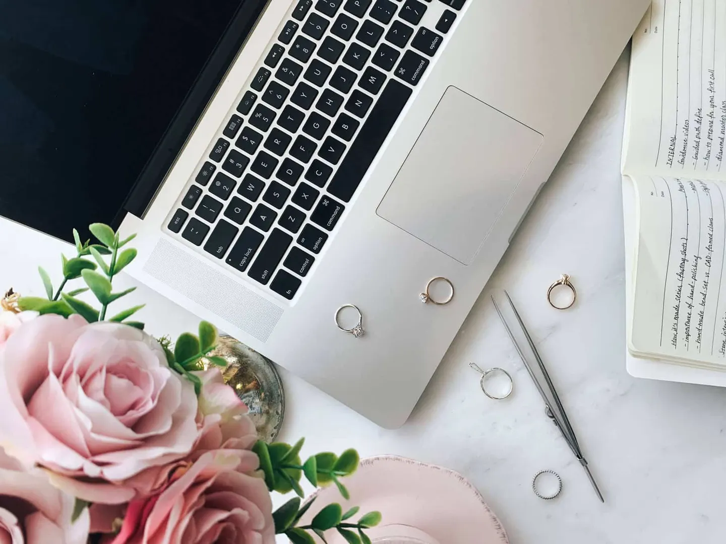 Pale keyboard and a blush rose on a desk, backdrop for the enquiry form
