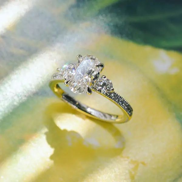 Oval And Round Three Stone Engagement Ring With Pavé