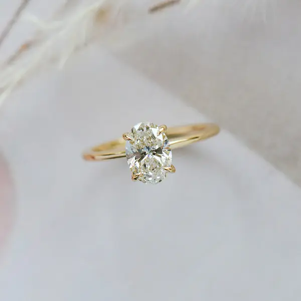 Oval Solitaire Engagement Ring With Hidden Halo And Tapered Band