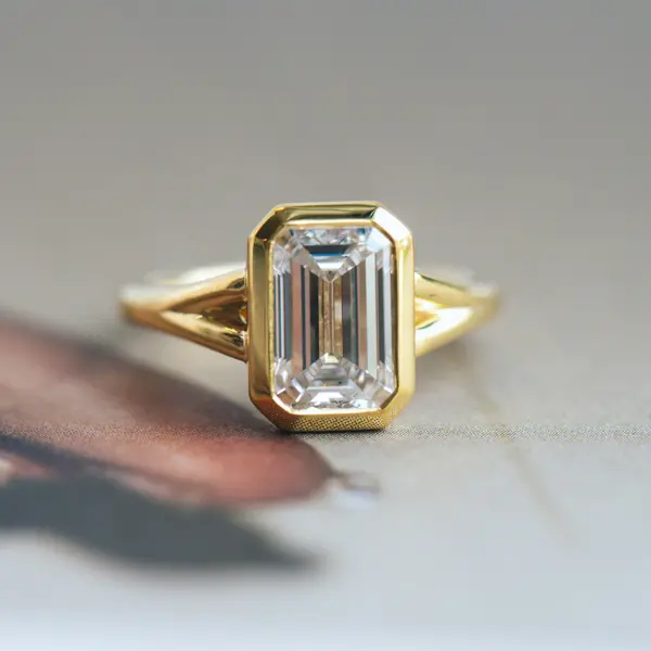 Bezel Set Emerald Engagement Ring With Split-Shank Band
