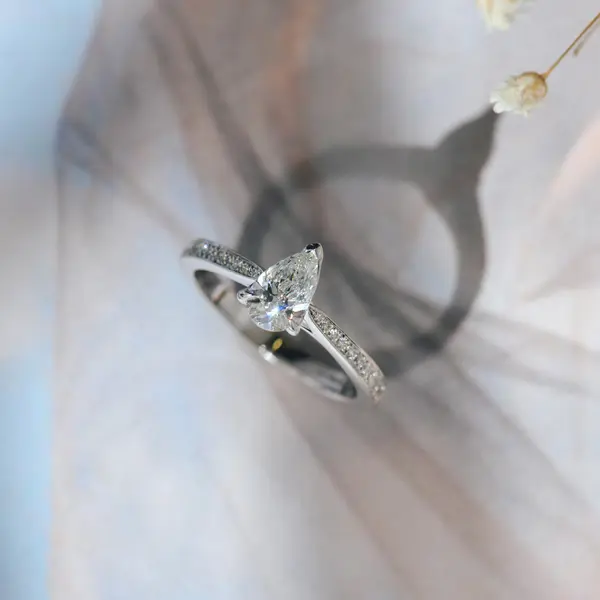 V-Tip Pear Engagement Ring With Tapered Pavé Band