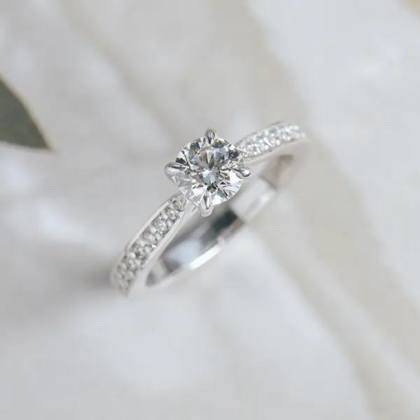 Round Engagement Ring With Channel Set Tapered Band