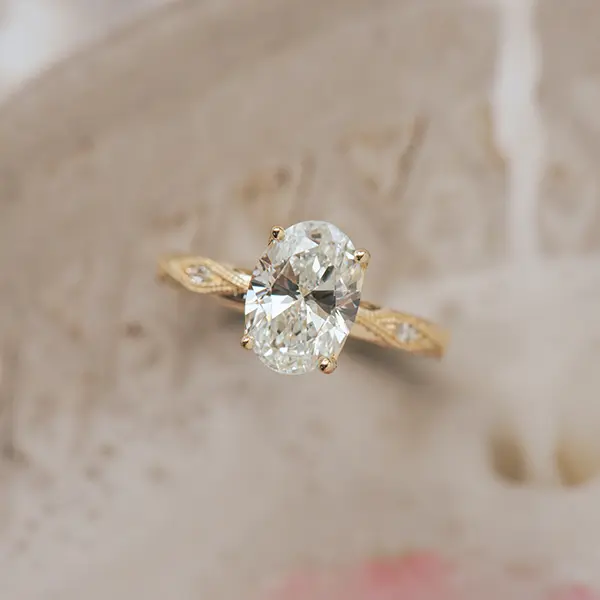 Oval Engagement Ring With Round Stones in Marquise-Shaped Cutout