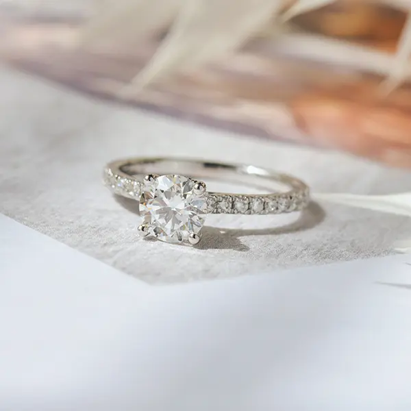 Round Engagement Ring With Hidden Halo Around the Prongs