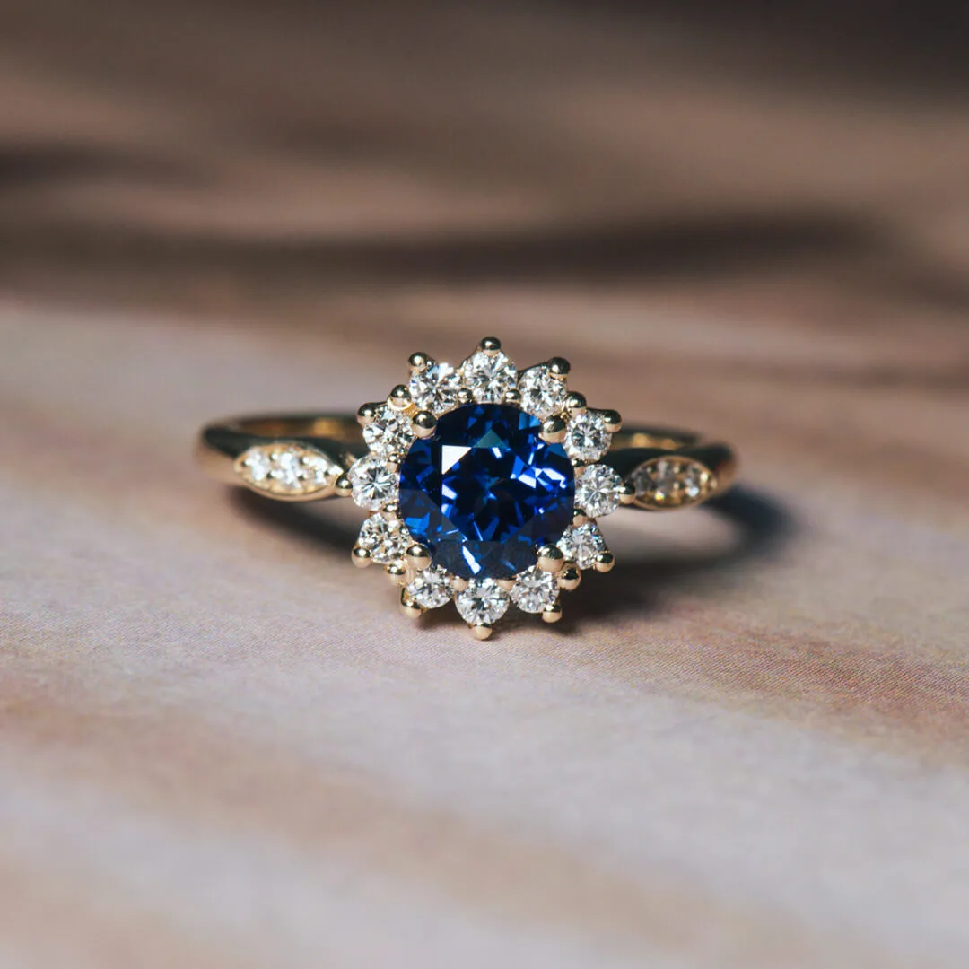 Round halo blue sapphire engagement ring in yellow gold