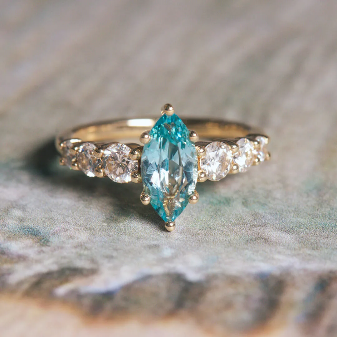 Marquise aqua blue sapphire engagement ring in yellow gold with diamond accents