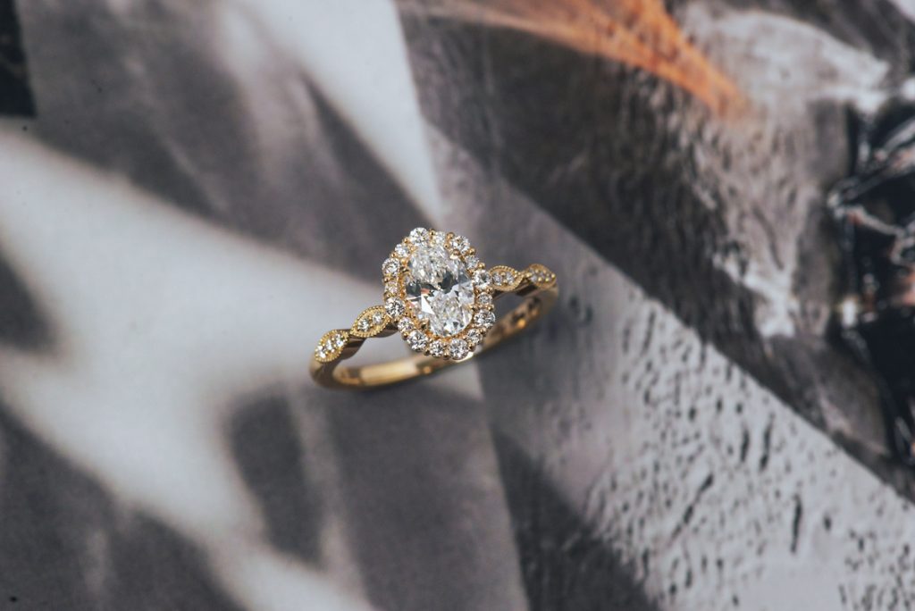how much should you spend on your engagemen ring: lab grown diamond oval engagement ring with vintage style halo